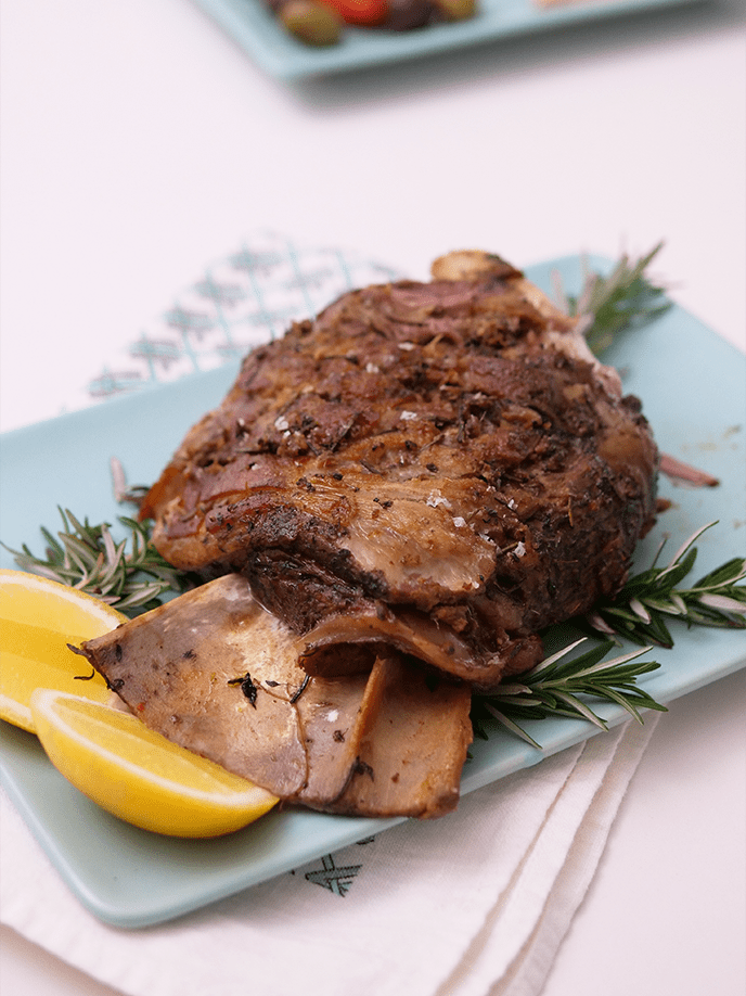 Slow Cooked Lamb Shoulder with Anchovy, Herbs & Cherry Tomatoes